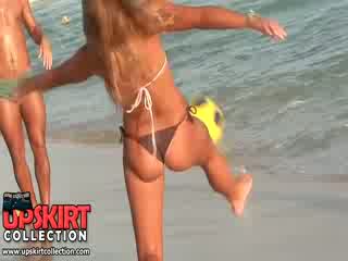 The tight bikini booty of hot chick is sexily shaking when she is playing with a ball